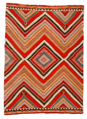 A Germantown textile featuring four small birds and bold diamond and serrated patterns in red, green, blue, yellow, pink, and more.